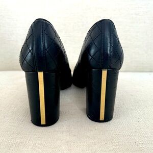Black leather pumps with gold heel detail